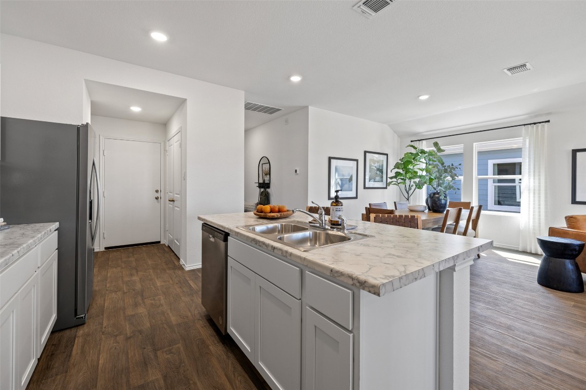 173 Balmorhea Street Kyle, TX 78640 - Photo 12 of 29 a view of living room with granite countertop furniture and wooden floor