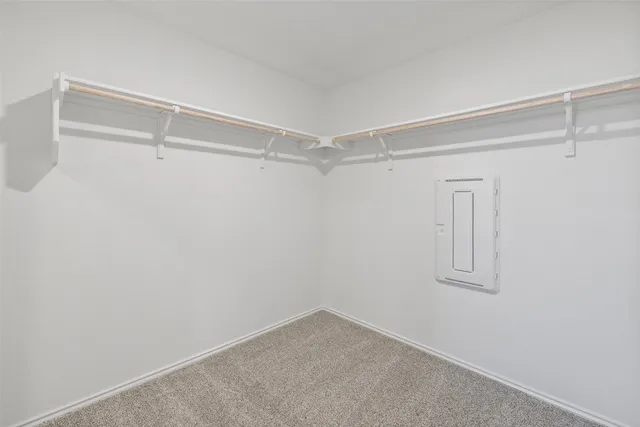 a view of a hallway with wooden floor and a dining room