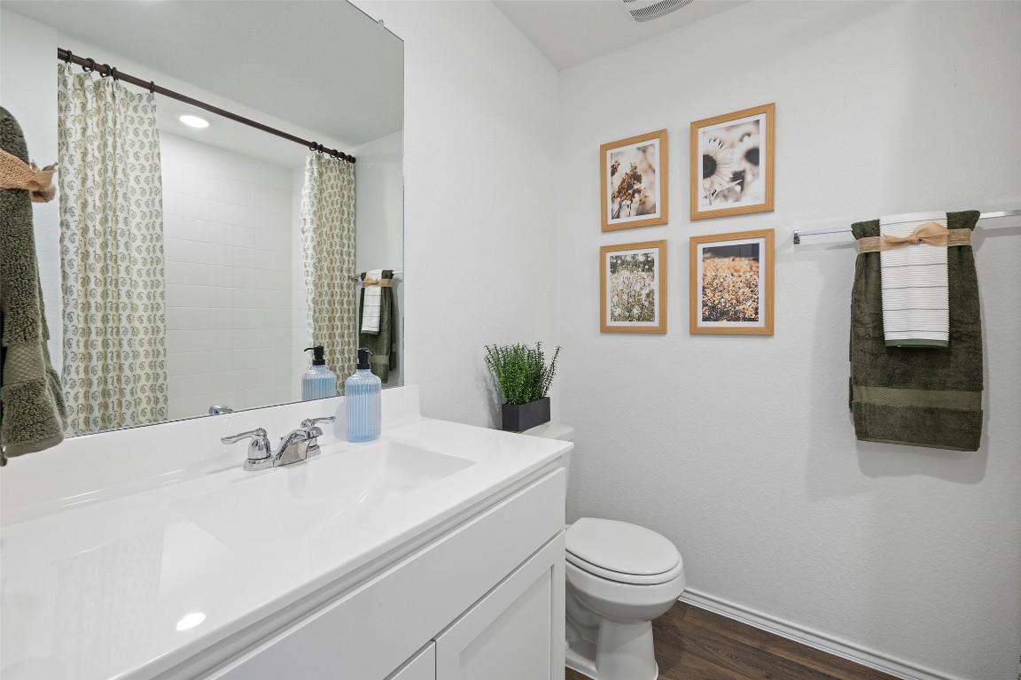 173 Balmorhea Street Kyle, TX 78640 - Photo 25 of 29 a bathroom with a sink and a mirror