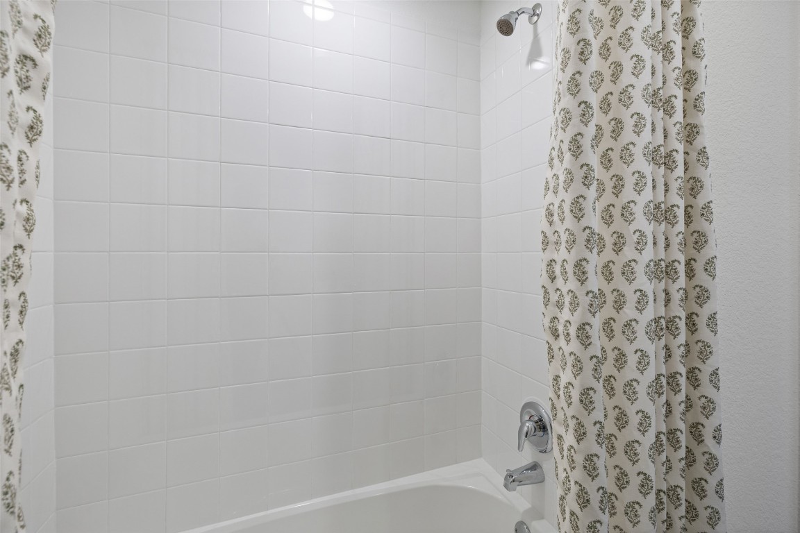 173 Balmorhea Street Kyle, TX 78640 - Photo 27 of 29 a bathroom with a bathtub and shower