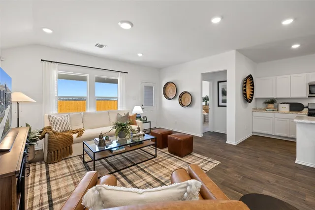 a living room with furniture and a kitchen