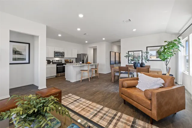 a living room with furniture and wooden floor