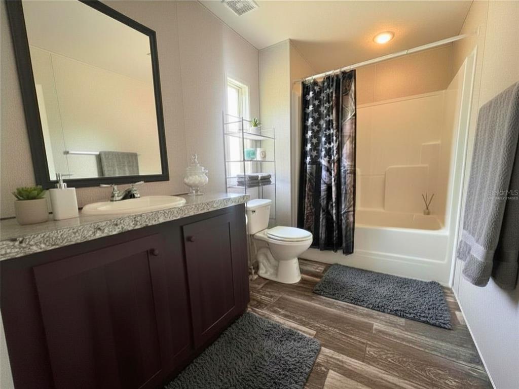 9827 Southeast Hoth Road Arcadia, FL 34266 - Photo 17 of 28 a bathroom with a granite countertop sink toilet and shower