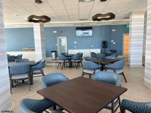 a view of a dining room with furniture and window