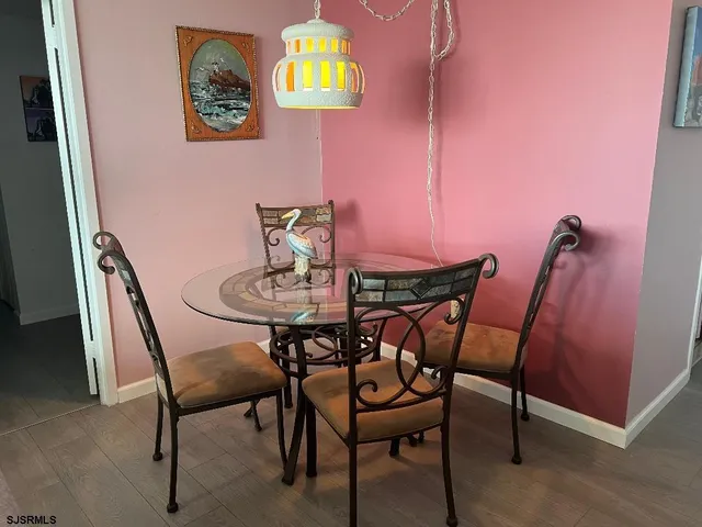 a view of a dining room with furniture and wooden floor