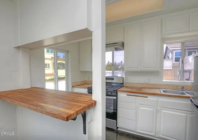 a kitchen with kitchen island a sink stove and refrigerator