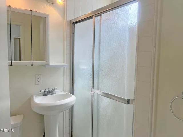 a bathroom with a sink a mirror and a shower