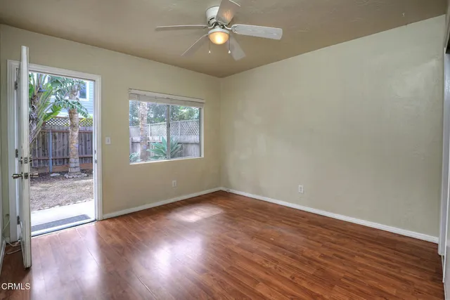 wooden floor in an empty room with a window