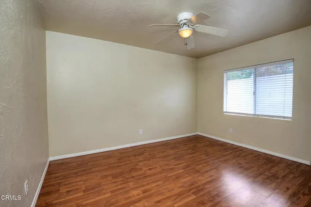 a view of room with window and ceiling fan