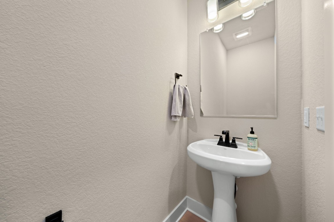 8417 Laughlin Lane Austin, TX 78744 - Photo 11 of 38 a bathroom with a sink and mirror