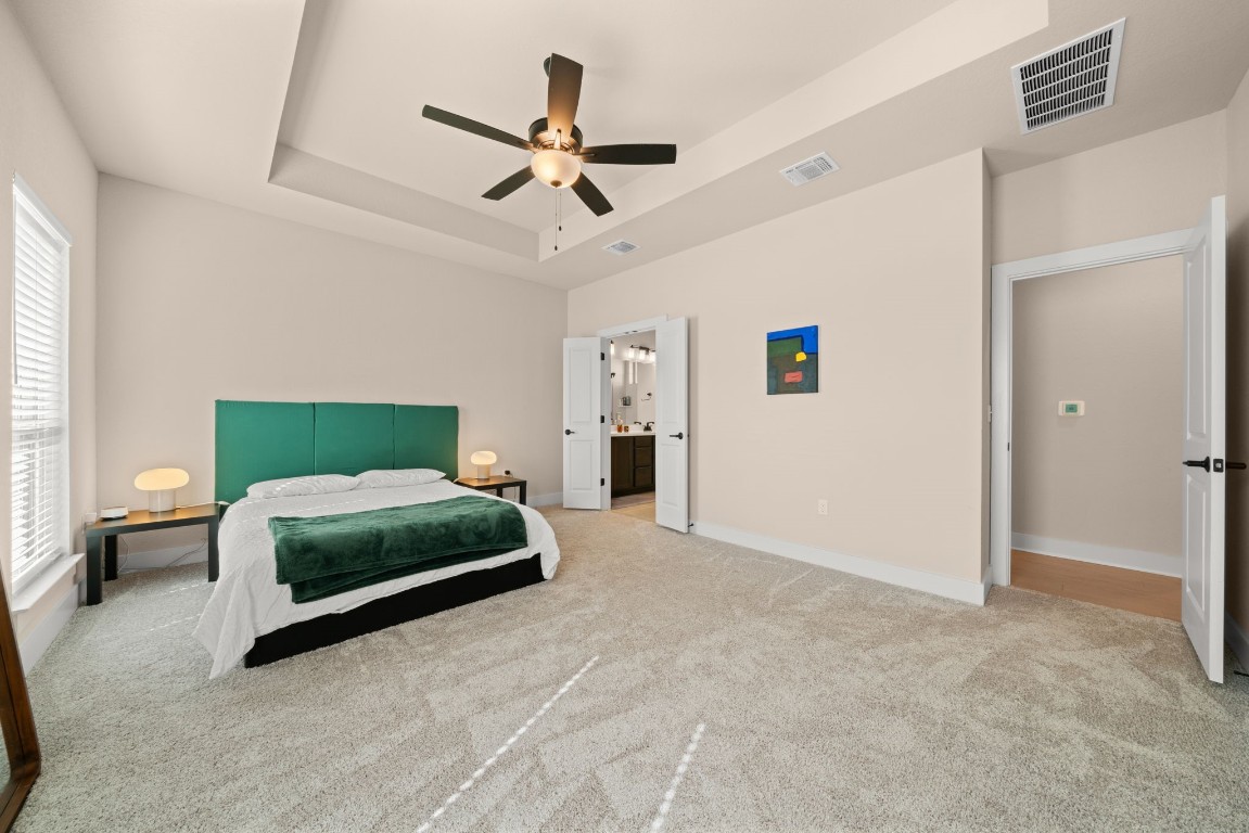 8417 Laughlin Lane Austin, TX 78744 - Photo 13 of 38 a bedroom with a bed and a chandelier