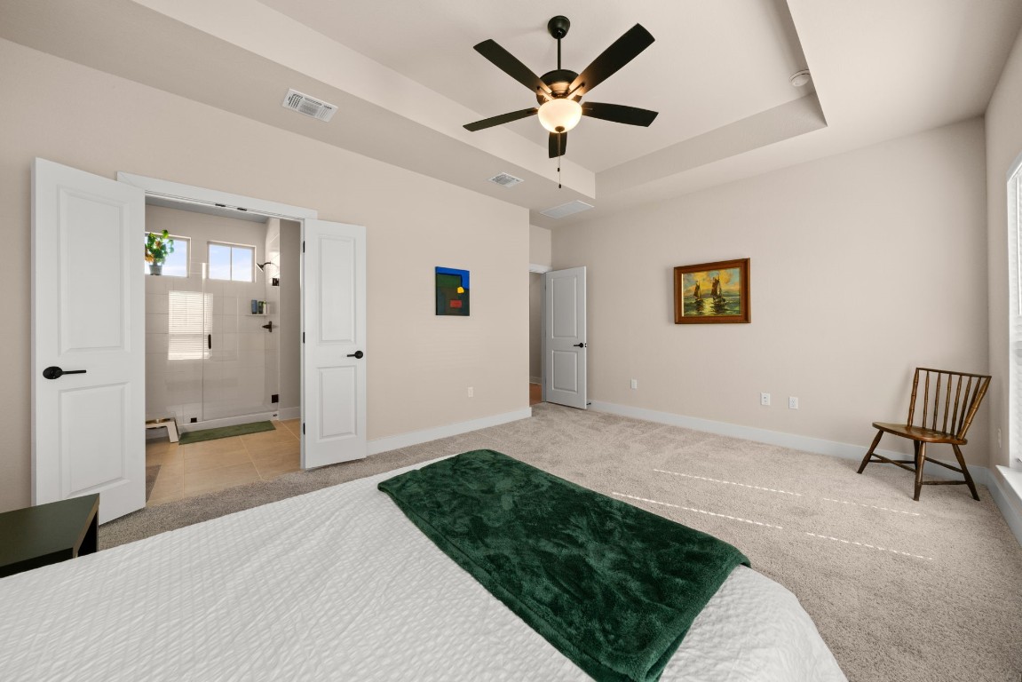 8417 Laughlin Lane Austin, TX 78744 - Photo 14 of 38 a spacious bedroom with a bed and a chandelier