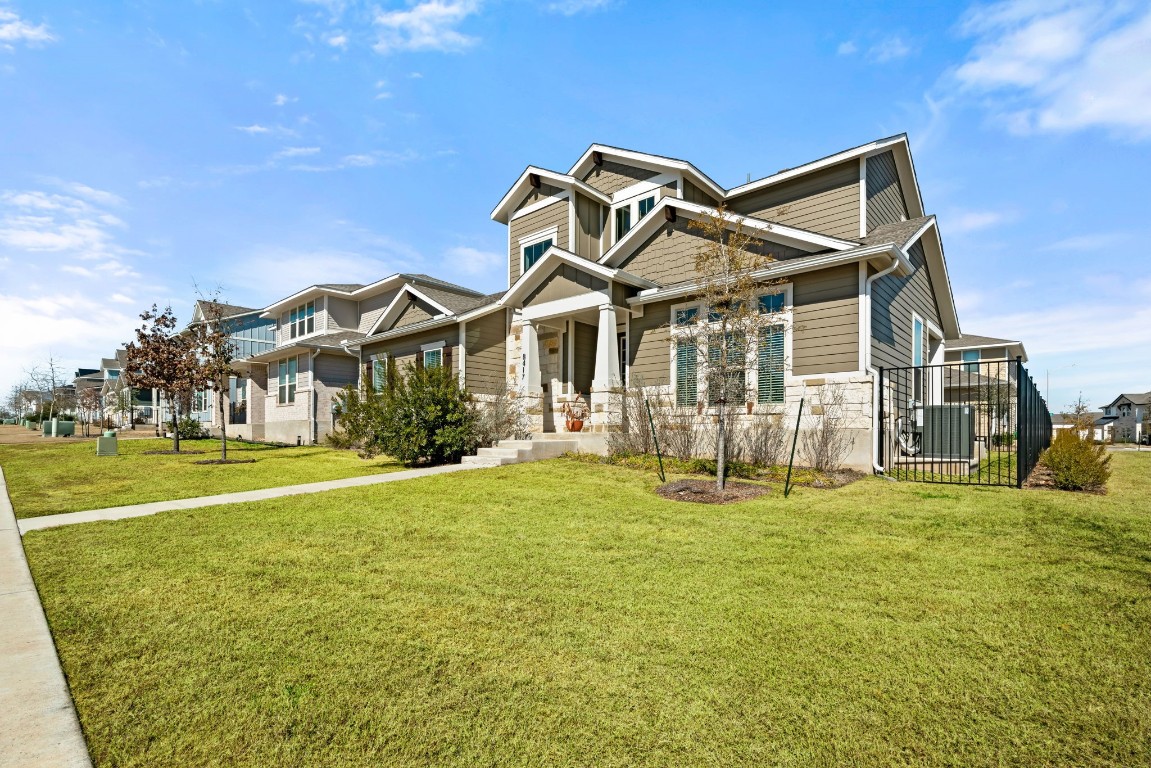 8417 Laughlin Lane Austin, TX 78744 - Photo 2 of 38 a front view of a house with a garden and porch