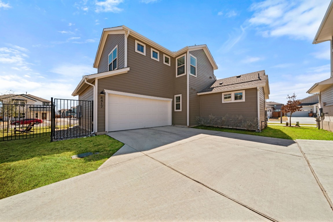 8417 Laughlin Lane Austin, TX 78744 - Photo 28 of 38 a front view of a house with a yard