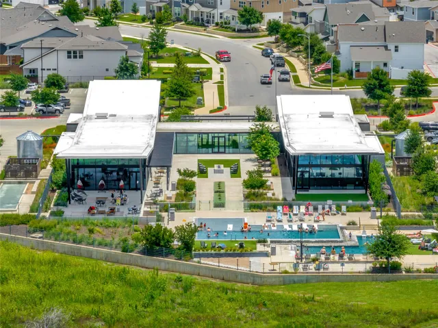 an aerial view of a house with a garden and swimming pool