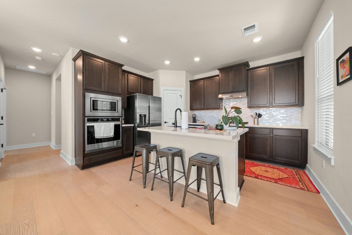 8417 Laughlin Lane Austin, TX 78744 - Photo 5 of 38 a kitchen with stainless steel appliances granite countertop a refrigerator and a stove top oven