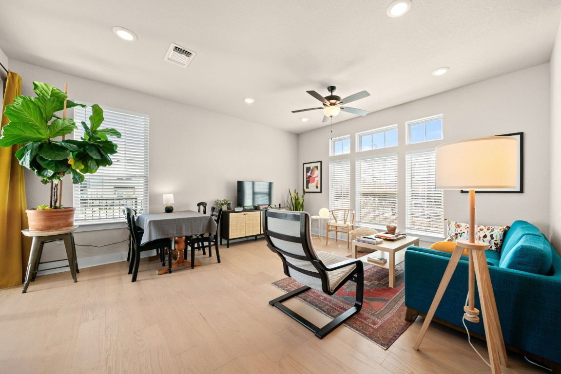 8417 Laughlin Lane Austin, TX 78744 - Photo 7 of 38 a living room with furniture a dining table and a potted plant