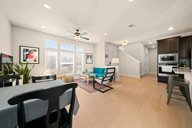 a living room with furniture a large window and a table