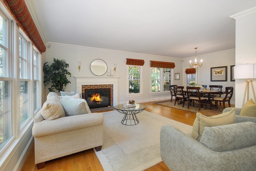 96 Forest Ridge Road, Unit 96 Concord, MA 01742 - Photo 12 of 36 a living room with furniture a fireplace a rug and a large window