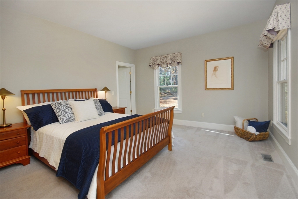 96 Forest Ridge Road, Unit 96 Concord, MA 01742 - Photo 17 of 36 a bedroom with bed and window