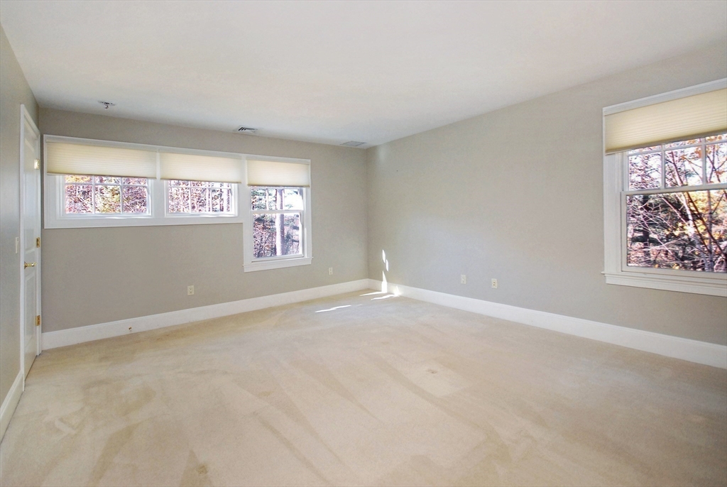 96 Forest Ridge Road, Unit 96 Concord, MA 01742 - Photo 23 of 36 an empty room with windows and closet