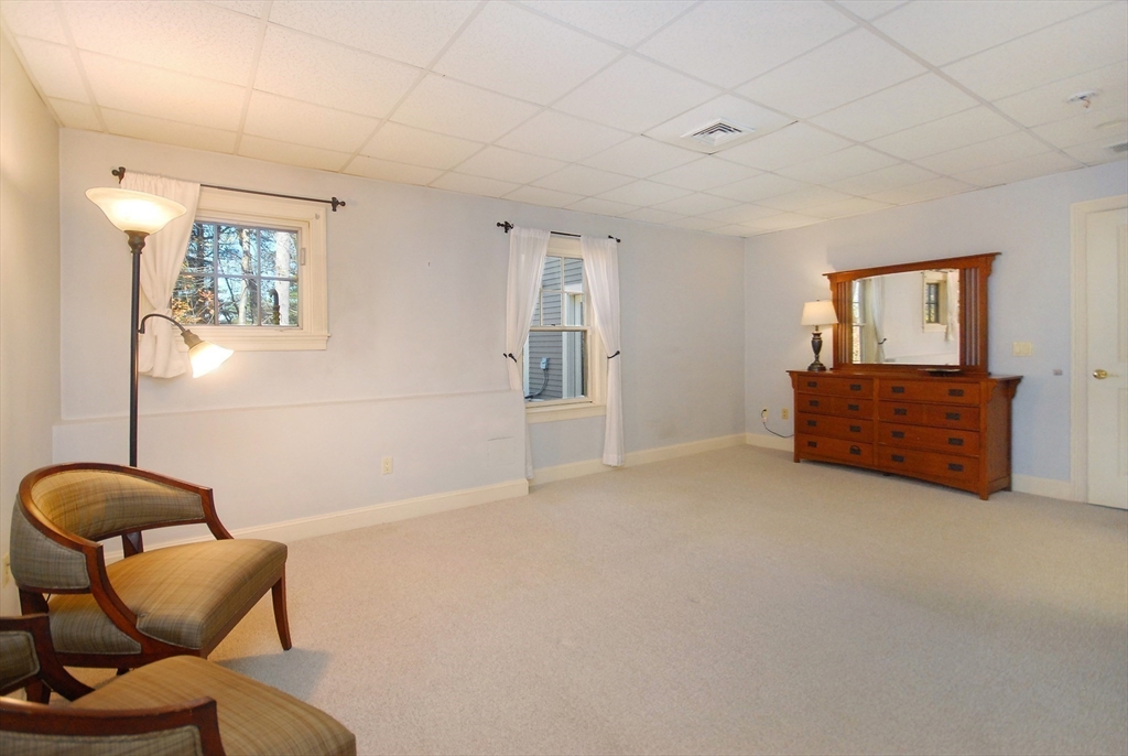 96 Forest Ridge Road, Unit 96 Concord, MA 01742 - Photo 26 of 36 a living room with furniture and a couch