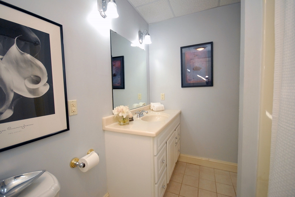 96 Forest Ridge Road, Unit 96 Concord, MA 01742 - Photo 27 of 36 a bathroom with a sink mirror and vanity