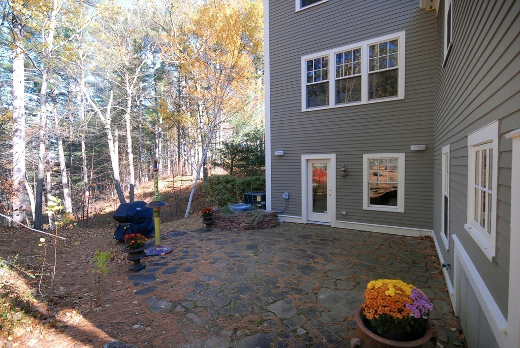 96 Forest Ridge Road, Unit 96 Concord, MA 01742 - Photo 29 of 36 a backyard of a house with outdoor seating