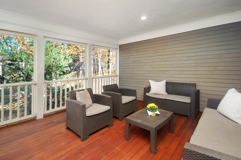 96 Forest Ridge Road, Unit 96 Concord, MA 01742 - Photo 31 of 36 a living room with furniture and a wooden floor