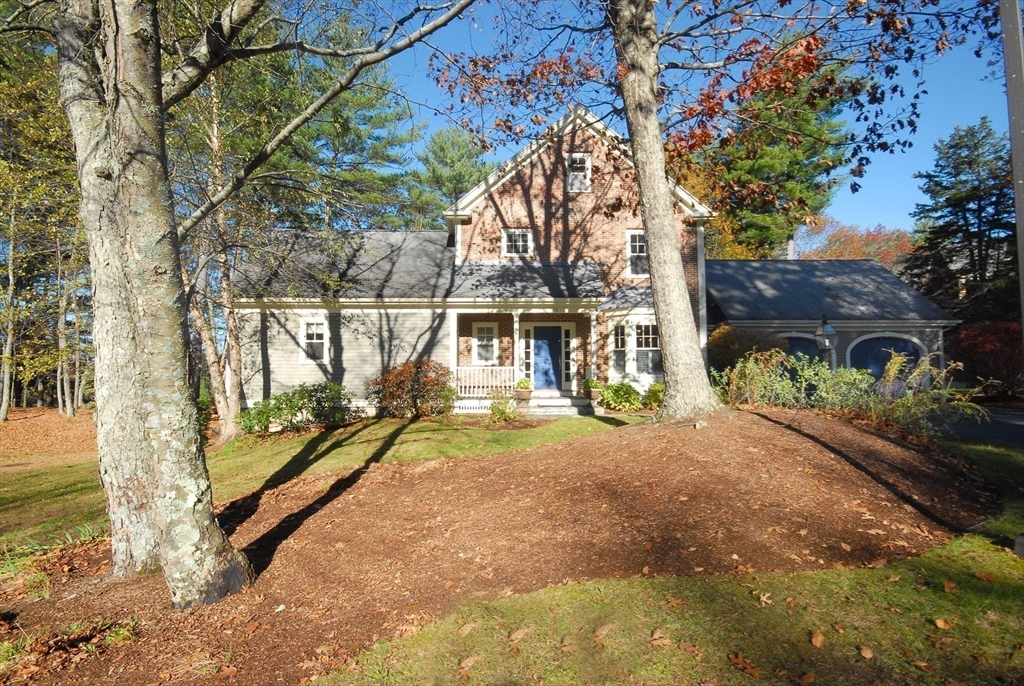 96 Forest Ridge Road, Unit 96 Concord, MA 01742 - Photo 35 of 36 a view of a bench in a yard next to a house