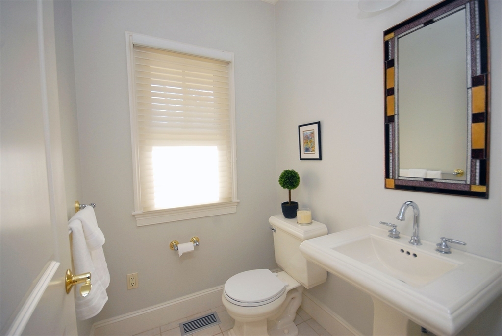 96 Forest Ridge Road, Unit 96 Concord, MA 01742 - Photo 10 of 36 a bathroom with a sink a toilet and a mirror