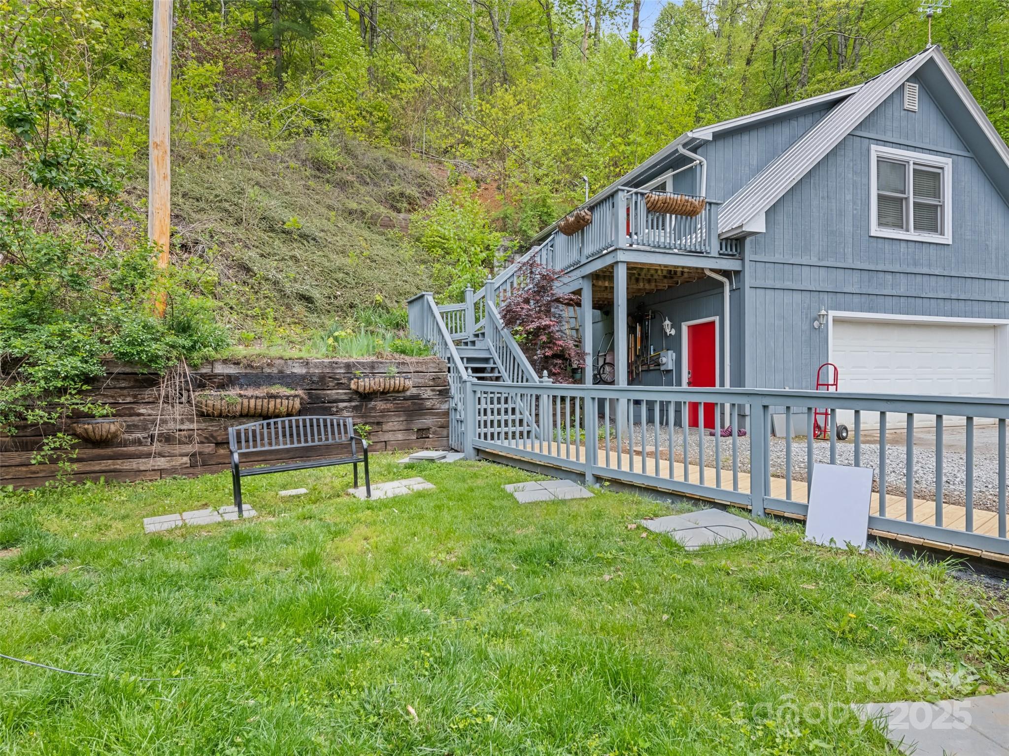 195 Three Springs Drive Sylva, NC 28779 - Photo 41 of 48 a view of an house with backyard and a deck