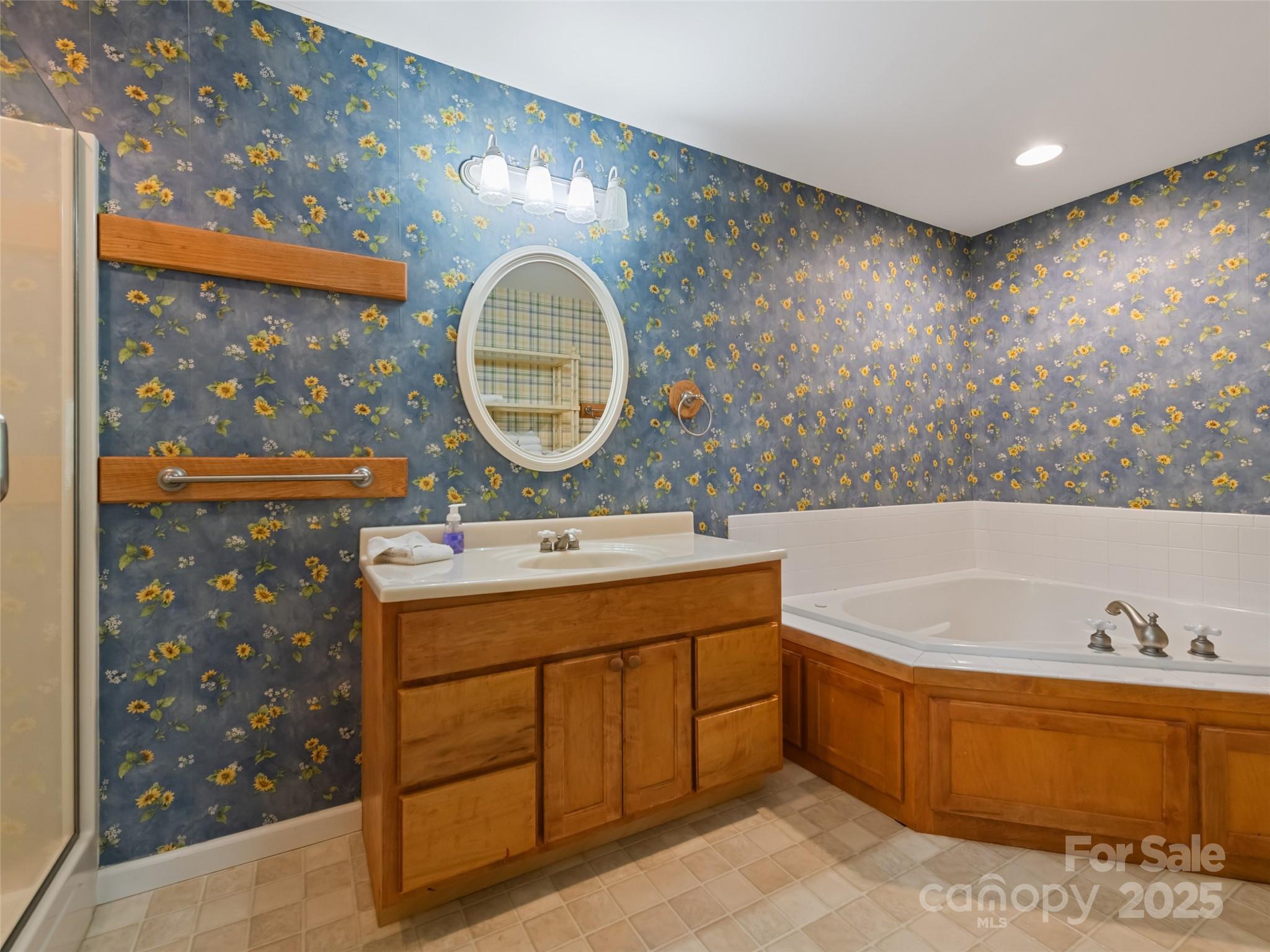 195 Three Springs Drive Sylva, NC 28779 - Photo 45 of 48 a bathroom with a tub sink and mirror