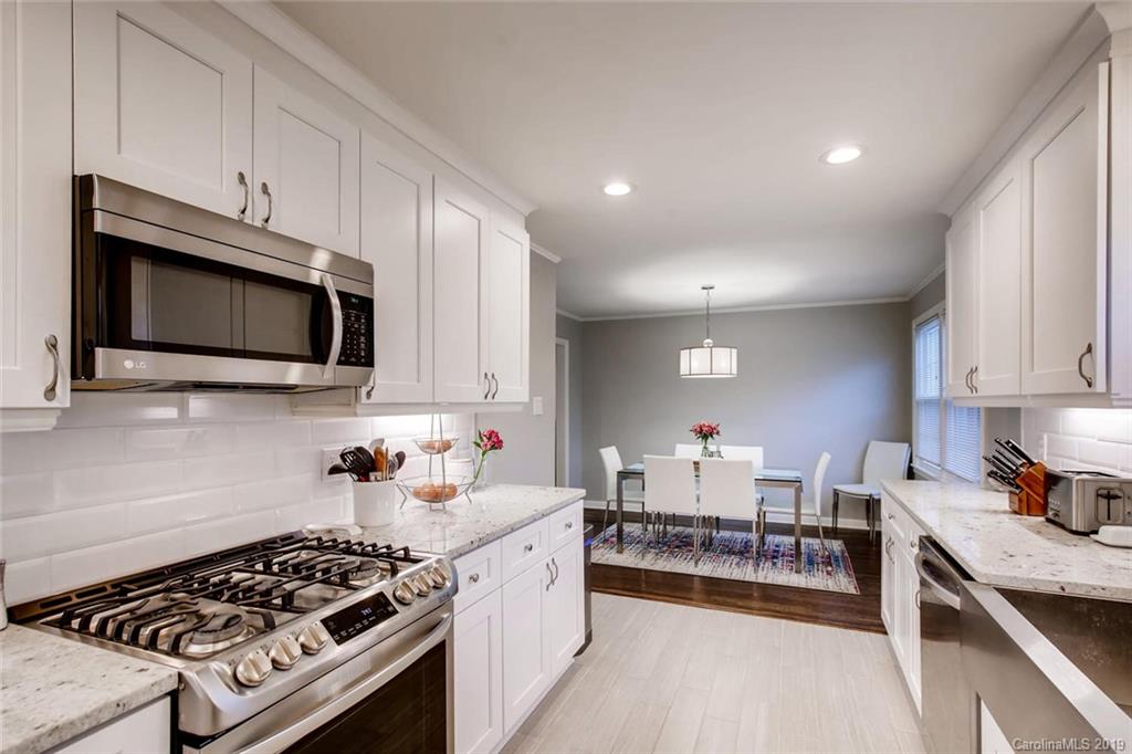 4400 Applegate Road Charlotte, NC 28209 - Photo 8 of 27 a kitchen with stainless steel appliances a stove a sink cabinets and a wooden floor