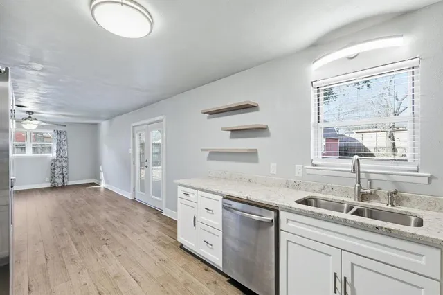 a kitchen with a sink cabinets and window