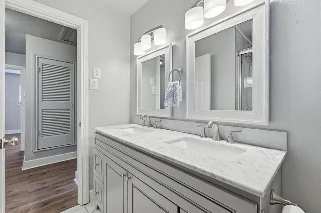 a bathroom with a granite countertop sink and a mirror