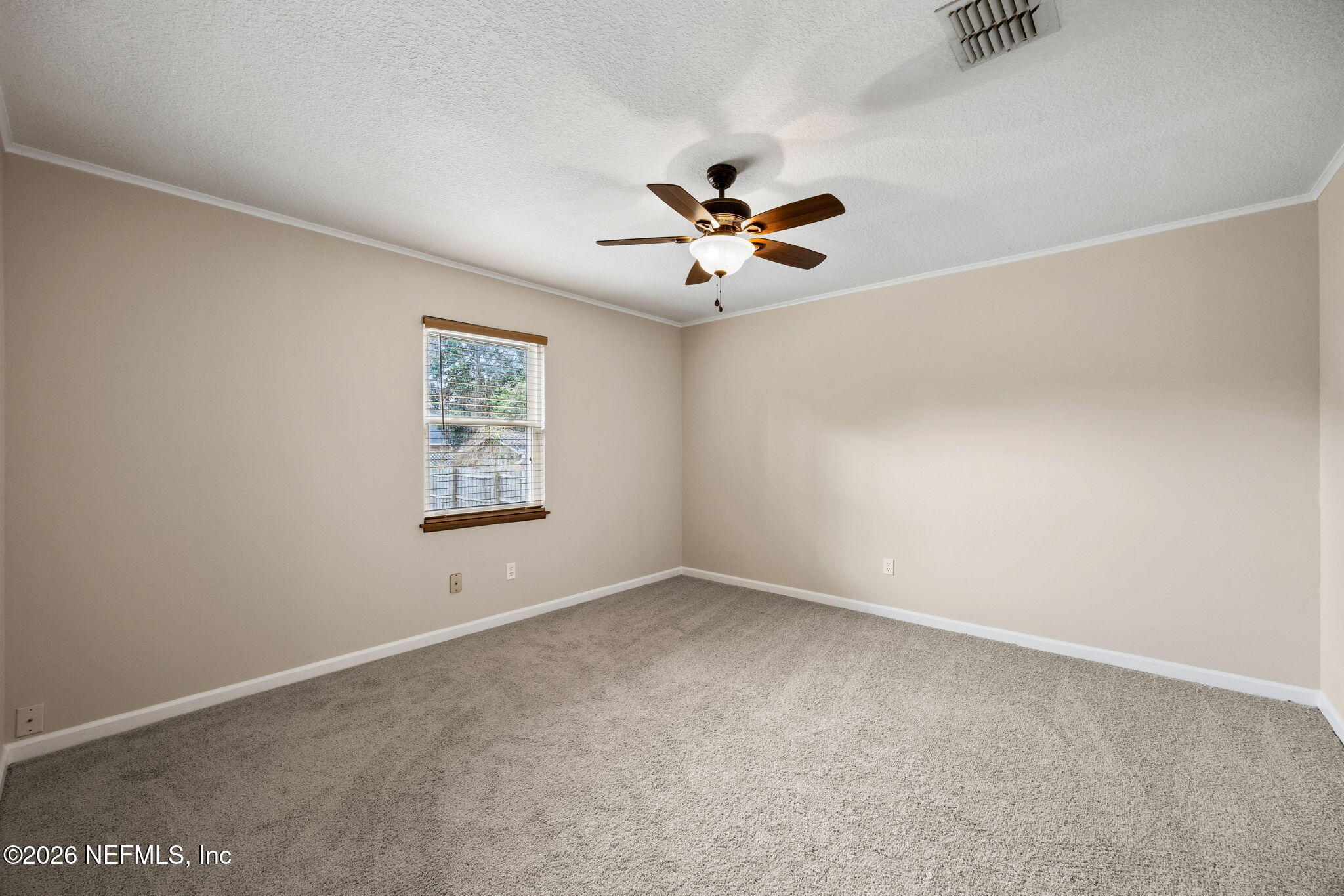 1888 Clemson Road Jacksonville, FL 32217 - Photo 33 of 41 an empty room with a window and a fan