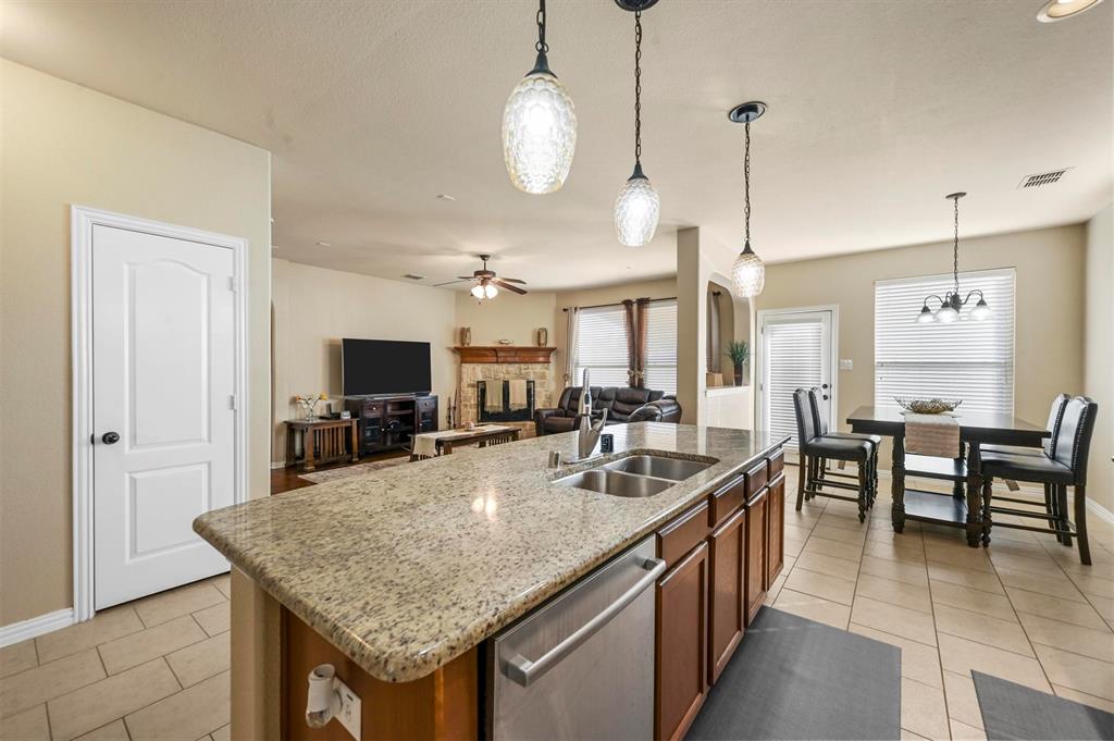 14815 Frisco Ranch Drive Little Elm, TX 75068 - Photo 11 of 40 a kitchen with center island table and chairs