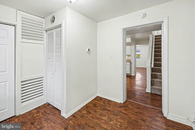 a view of hallway with wooden floor