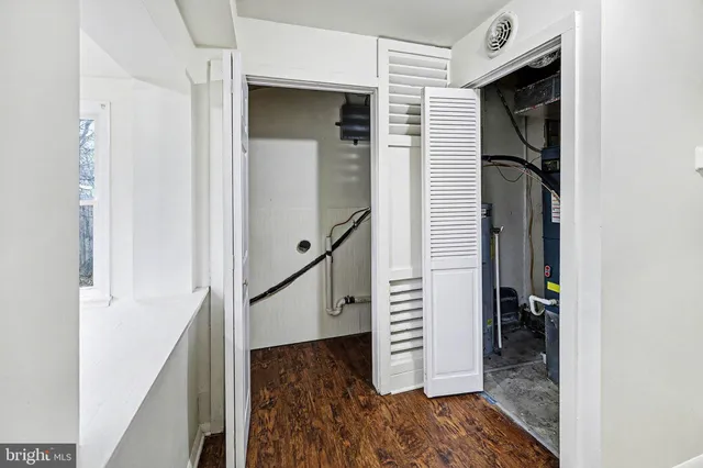 a view of hallway with stairs and wooden floor