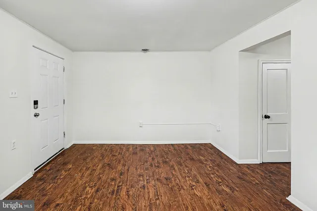 a view of a room with wooden floor