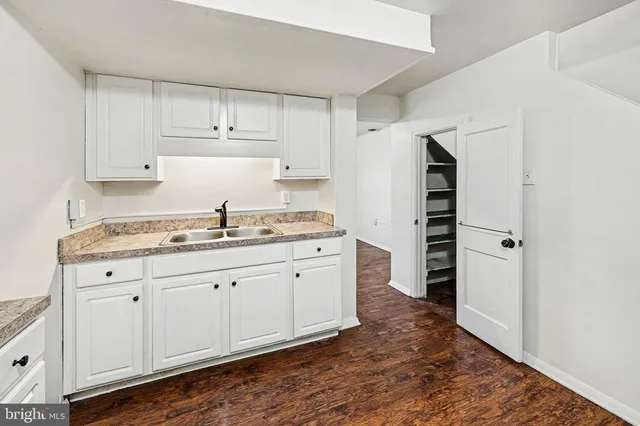 a kitchen with granite countertop a refrigerator and a sink
