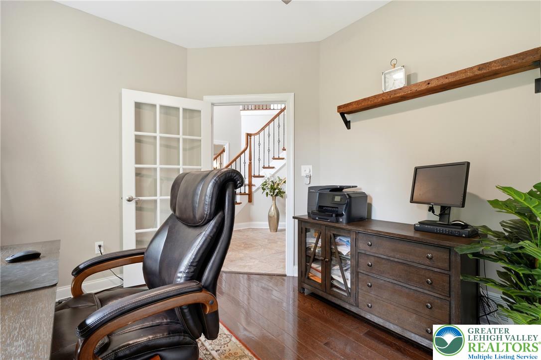 245 East Dell Road Bath, PA 18014 - Photo 28 of 99 French doors open into a bright study with rich hardwood flooring and a stylish built-in shelf.
