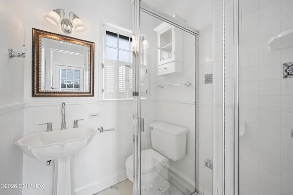 a bathroom with a shower and sink