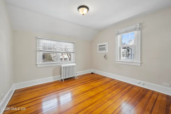 a view of a room with wooden floor and window