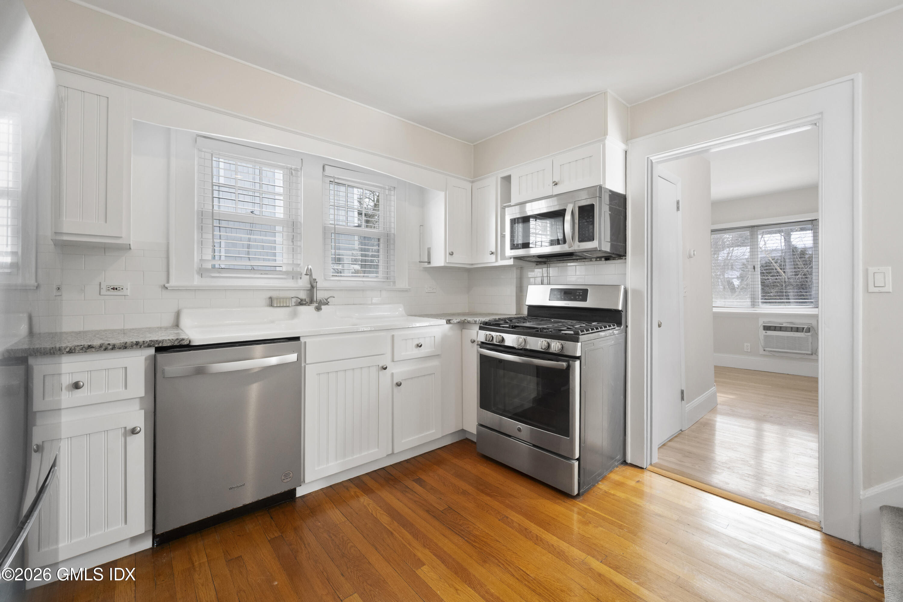 10 Anthony Place Riverside, CT 06878 - Photo 8 of 24 a kitchen with stainless steel appliances white cabinets and a stove top oven