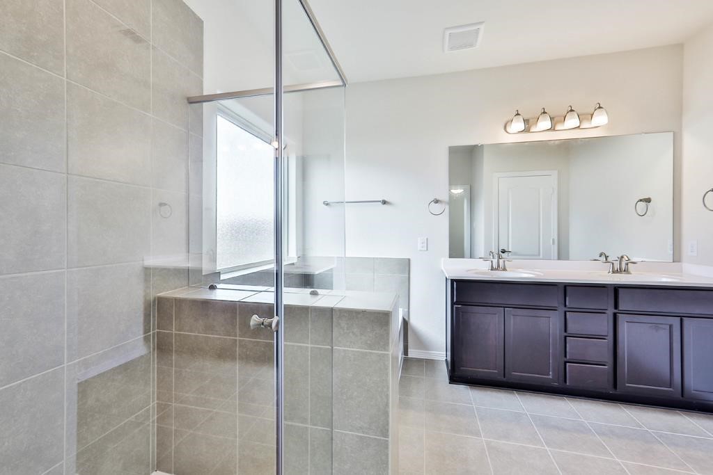247 Sintra Lk Way Rosenberg, TX 77469 - Photo 16 of 28 a bathroom with a double vanity sink and a mirror