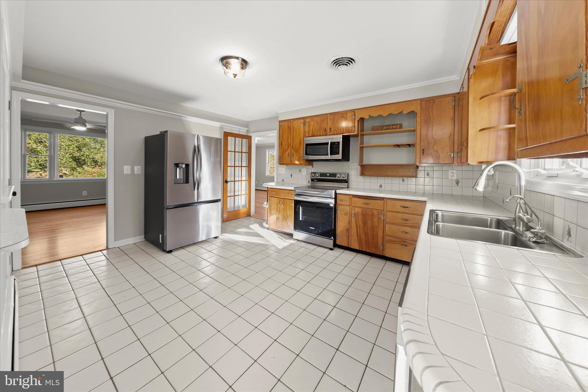12775 Frederick Road West Friendship, MD 21794 - Photo 20 of 65 a kitchen with stainless steel appliances a stove a sink and a refrigerator