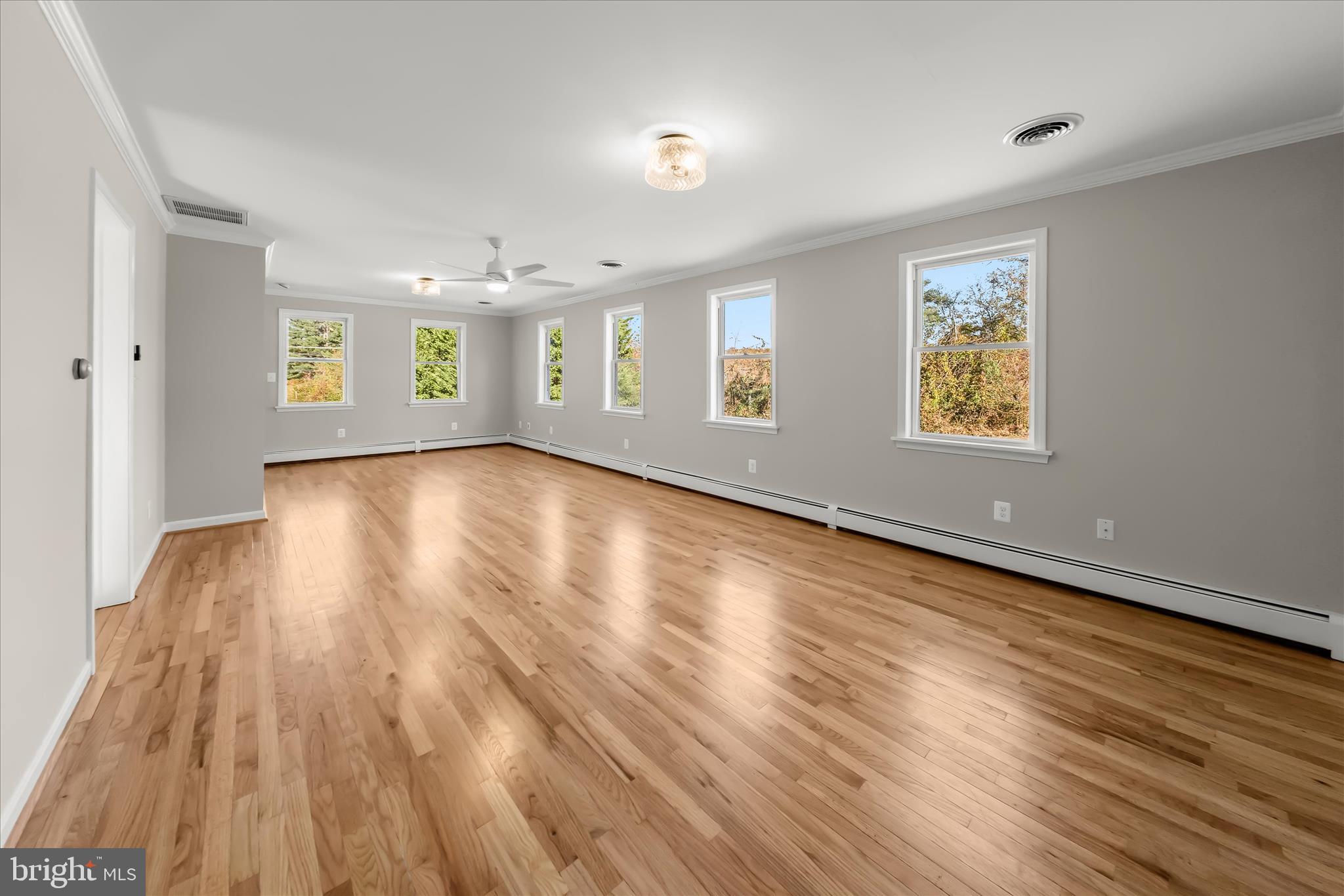 12775 Frederick Road West Friendship, MD 21794 - Photo 21 of 65 an empty room with wooden floor and windows
