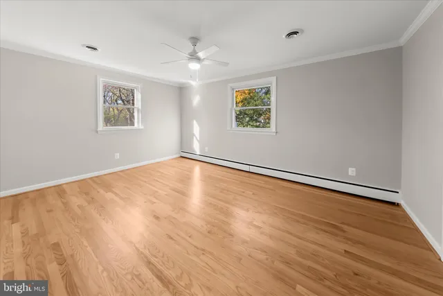 wooden floor in an empty room with a window